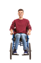 Handicapped young man in wheelchair on white background