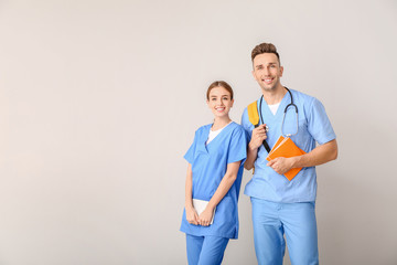 Medical students on light background