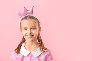 Cute little girl on color background