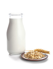 Bottle of tasty oat milk on white background