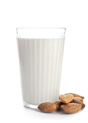Glass of tasty almond milk on white background