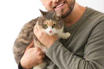 Man with cute cat at home