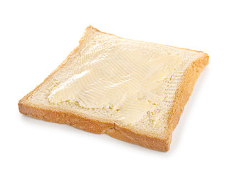 Slice of bread with butter on white background