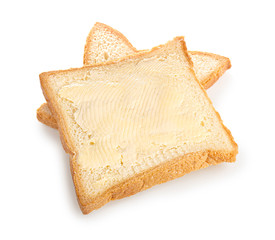 Slices of bread with butter on white background