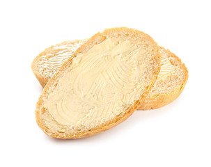 Slices of bread with butter on white background