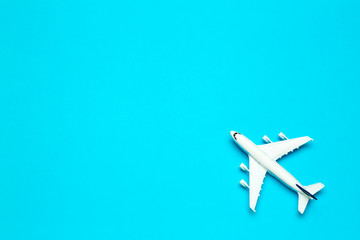 Travel minimal background. Model airplane in flight on an empty colored background. Copy space