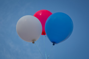 Blue,red, white balloon isolated on a blue background .Blue, red, white balloon sky background .