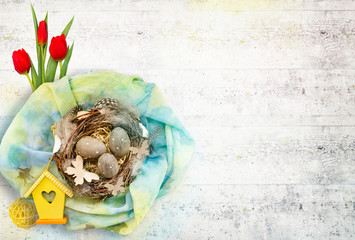 Spring composition by Easter: nest with eggs