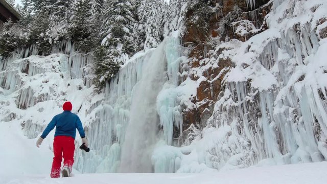 Snowshoeing Adventure Photographer Hikes Camera to Frozen Franklin Falls Waterfall