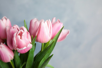 Beautiful pink spring tulips on light blue background, closeup. Space for text