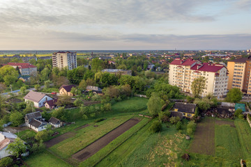 Aerial view of multistory apartment buildings in green residential area.