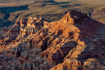 Geological layers within the face of a canyon cliff in the evening lights