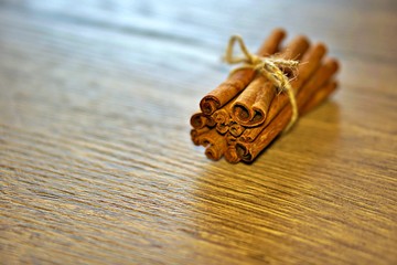 Cinnamon sticks on wooden table.