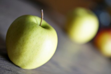 Red and green fresh apple fruit on the wood table.