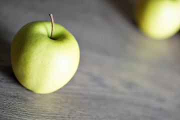 Red and green fresh apple fruit on the wood table.