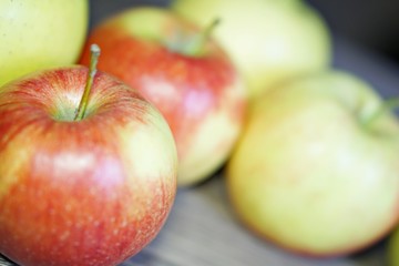 Red and green fresh apple fruit on the wood table.