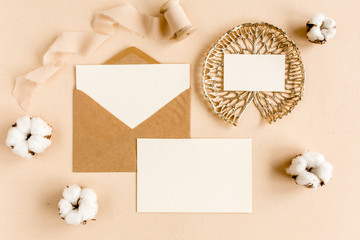 Mockup invitation, blank greeting card and craft envelope, cotton. Flat lay, top view.