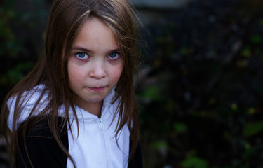 Cute little girl is standing alone and crying