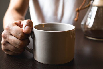 Hand Holding Coffee Mug