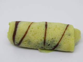 Close up view of kue basah or wet snack dadar gulung parutan kelapa gula jawa cair or ketayap a dessert roll omelet Crepes stuffed made filled glutinous rice flour, coconut steeped camels, palm sugar,