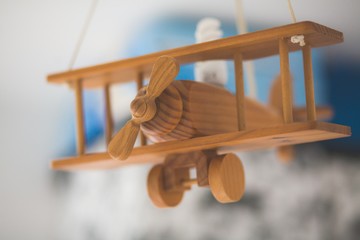 Closeup shot of a wooden miniature old airplane with a blurred background