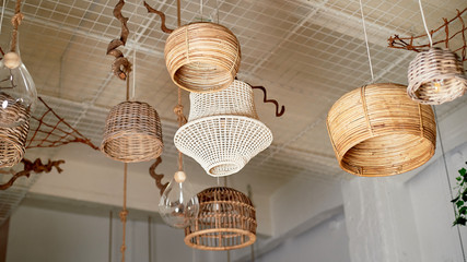 Many lamps of rattan, hay hang from the ceiling. Traditional and simple lighting.