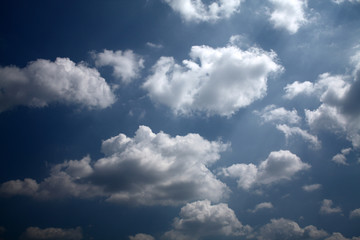 Fototapeta na wymiar storm clouds on deep blue sky