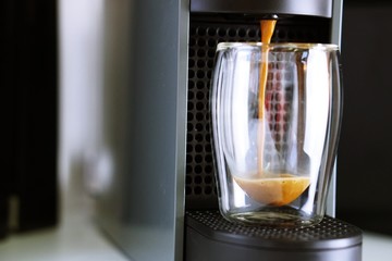 Coffee time in office. Capsule espresso in double glass cup - 100% arabica