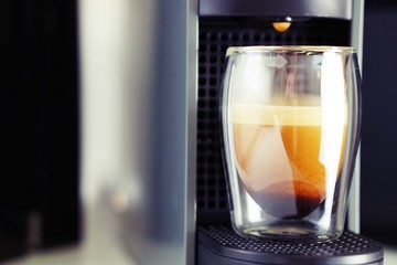 Coffee time in office. Capsule espresso in double glass cup - 100% arabica