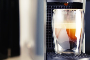 Coffee time in office. Capsule espresso in double glass cup - 100% arabica