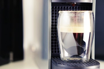 Coffee time in office. Capsule espresso in double glass cup - 100% arabica