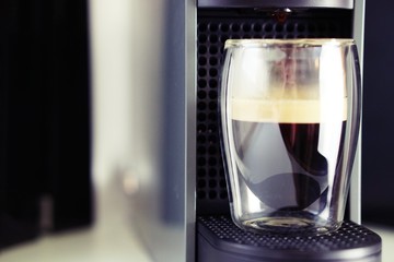 Coffee time in office. Capsule espresso in double glass cup - 100% arabica
