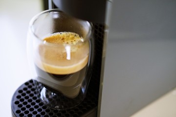 Coffee time in office. Capsule espresso in double glass cup - 100% arabica