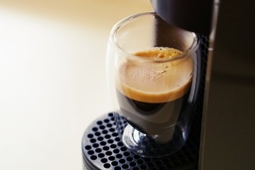 Coffee time in office. Capsule espresso in double glass cup - 100% arabica
