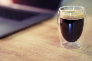 Coffee time in office. Capsule espresso in double glass cup - 100% arabica