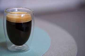 Coffee time in office. Capsule espresso in double glass cup - 100% arabica