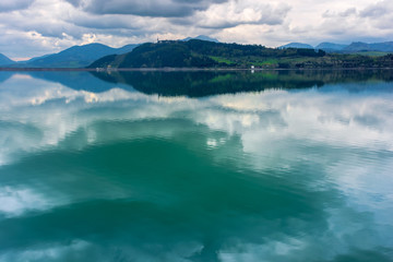 lake liptovska mara in slovakia. wondeful travel destination of high tatras mountain ridge. cloudy weather in springtime. reflection in the water