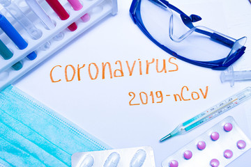 Coronavirus diagnostic and treatment analysis concept. Laboratory table with a respiratory mask, a...