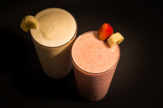 banana and strawberry smothies with black background