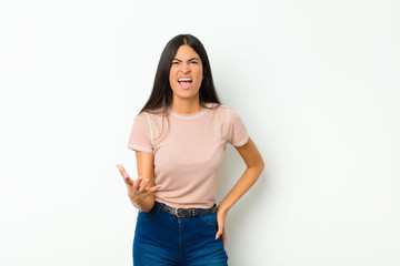 young pretty latin woman looking angry, annoyed and frustrated screaming wtf or what‚Äôs wrong...