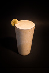 black background banana smoothie drink