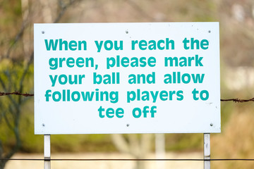 Golf course rules sign to allow players to tee off and mark ball