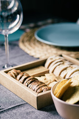Different bread toast slices on a wooden box on a prepared and served food table on a restaurant