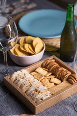 Different bread toast slices on a wooden box on a prepared and served food table on a restaurant