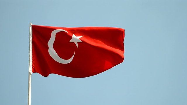 turkish red flag on blue sky under wind in sunny day, turkey travel diversity
