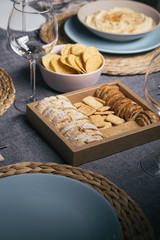 Different bread toast slices on a wooden box on a prepared and served food table on a restaurant