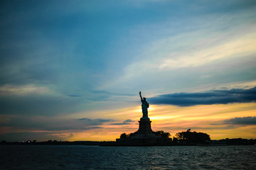 silhouette of statue of liberty at sunset © marco