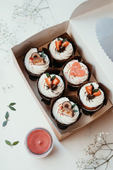 Cupcakes with strawberries and heart. Holiday cupcakes in box, dessert decoration. Gift for Valentine's Day.