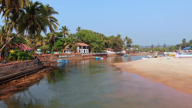 Aerial view of a small Indian river with wooden fishing boats on Baga Beach, Goa, India