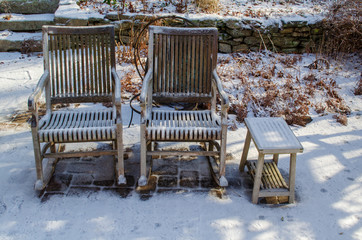 Two rockers in the garden waiting together for spring to arrive